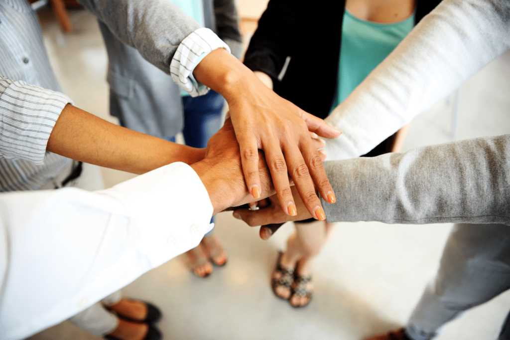 Pile of hands on top of each other