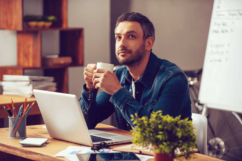 Man having a beverage while working