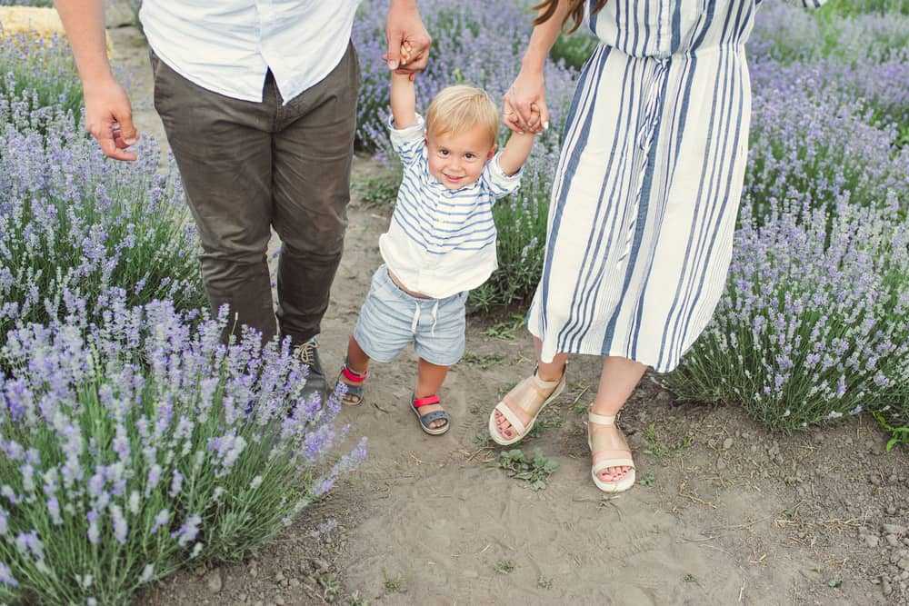Child holding parents hands