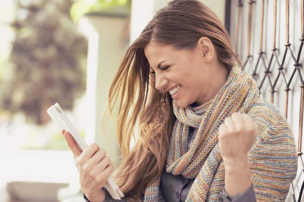 Woman happy looking at phone
