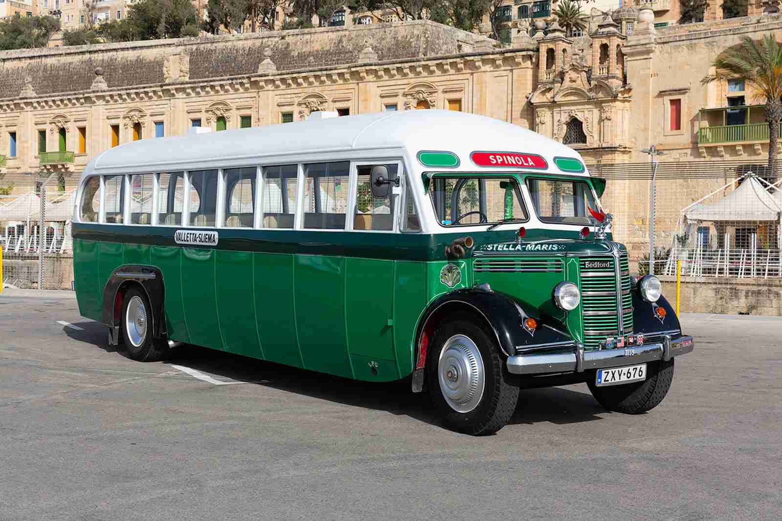 Restored green and white vintage Bedford bus named