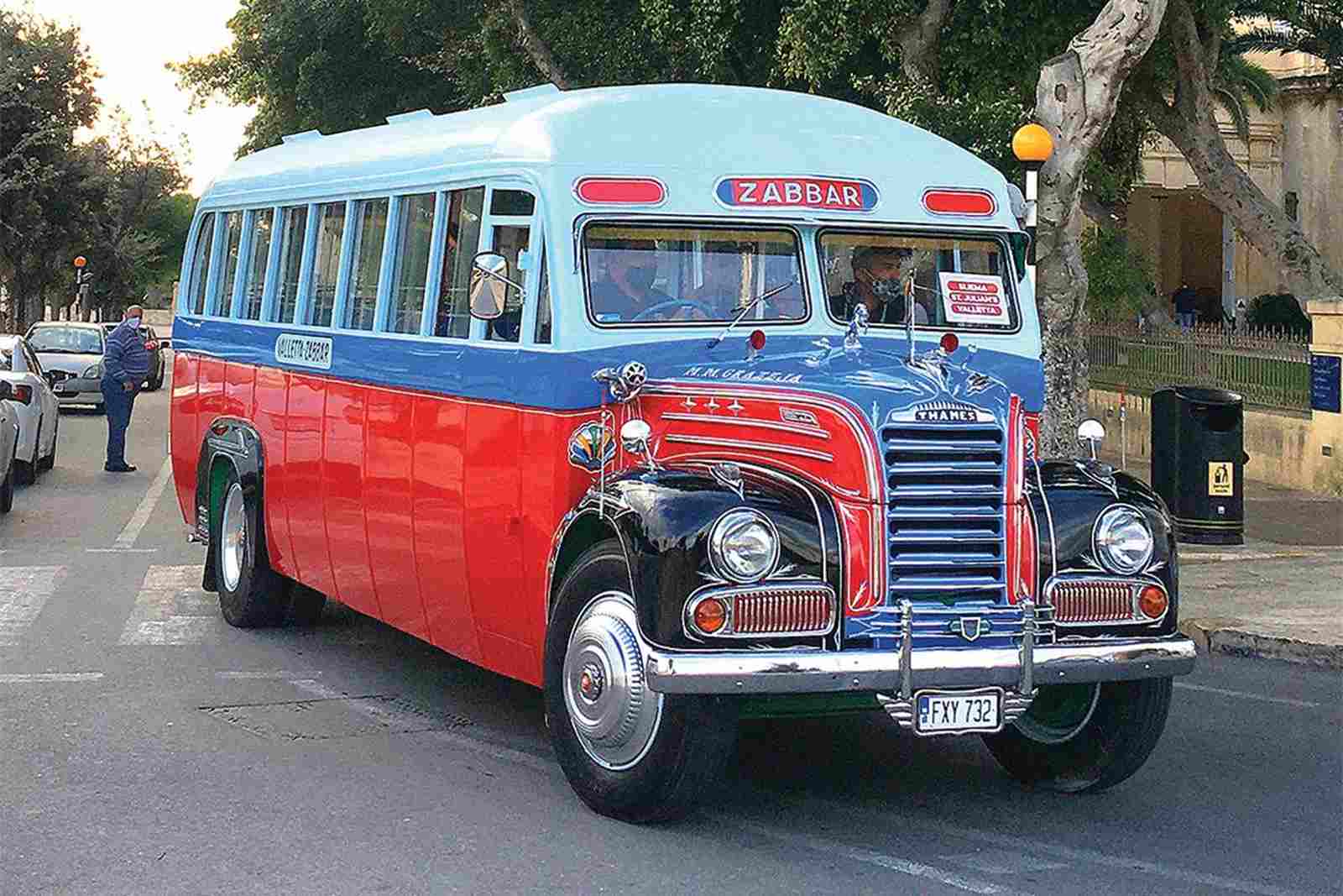 Restored blue, red and white vintage Thames bus