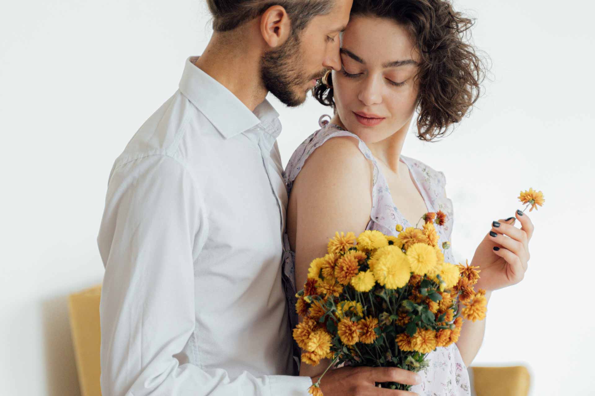 man giving flower bouquet to woman