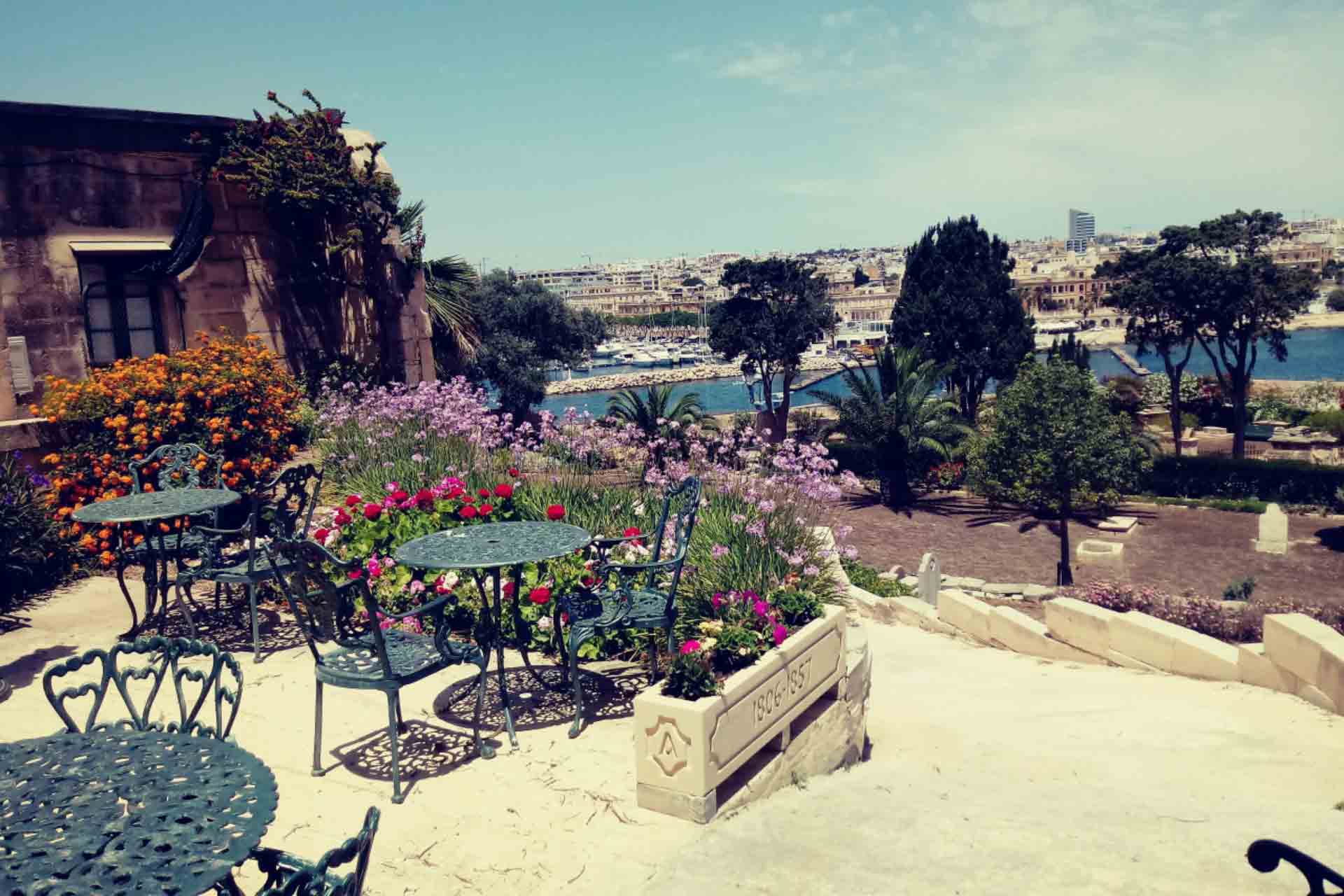 seating area surrounded with flowers Msida Bastion Historic Garden