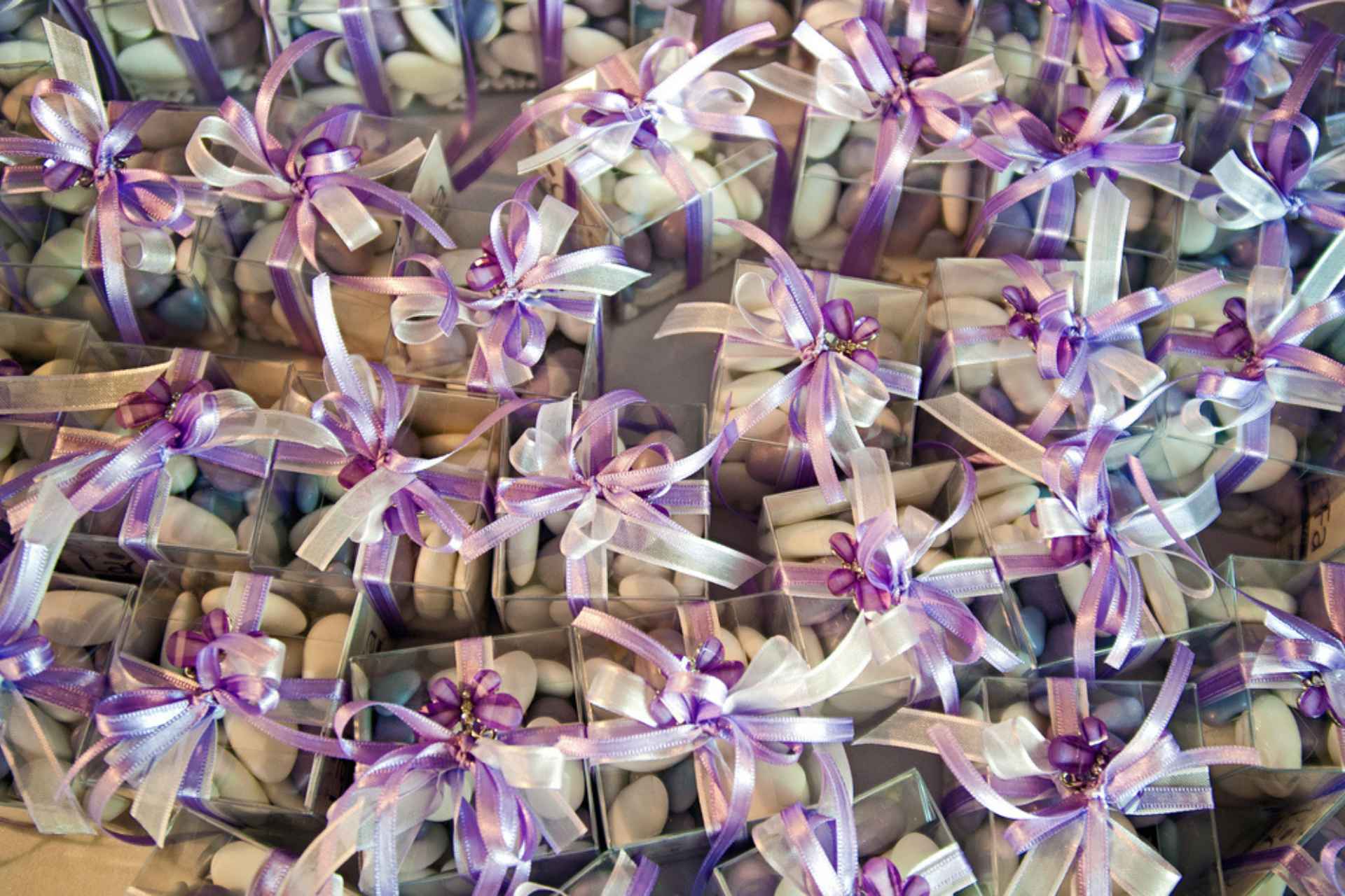 purple bow sealed gift boxes with perlini inside as wedding favours