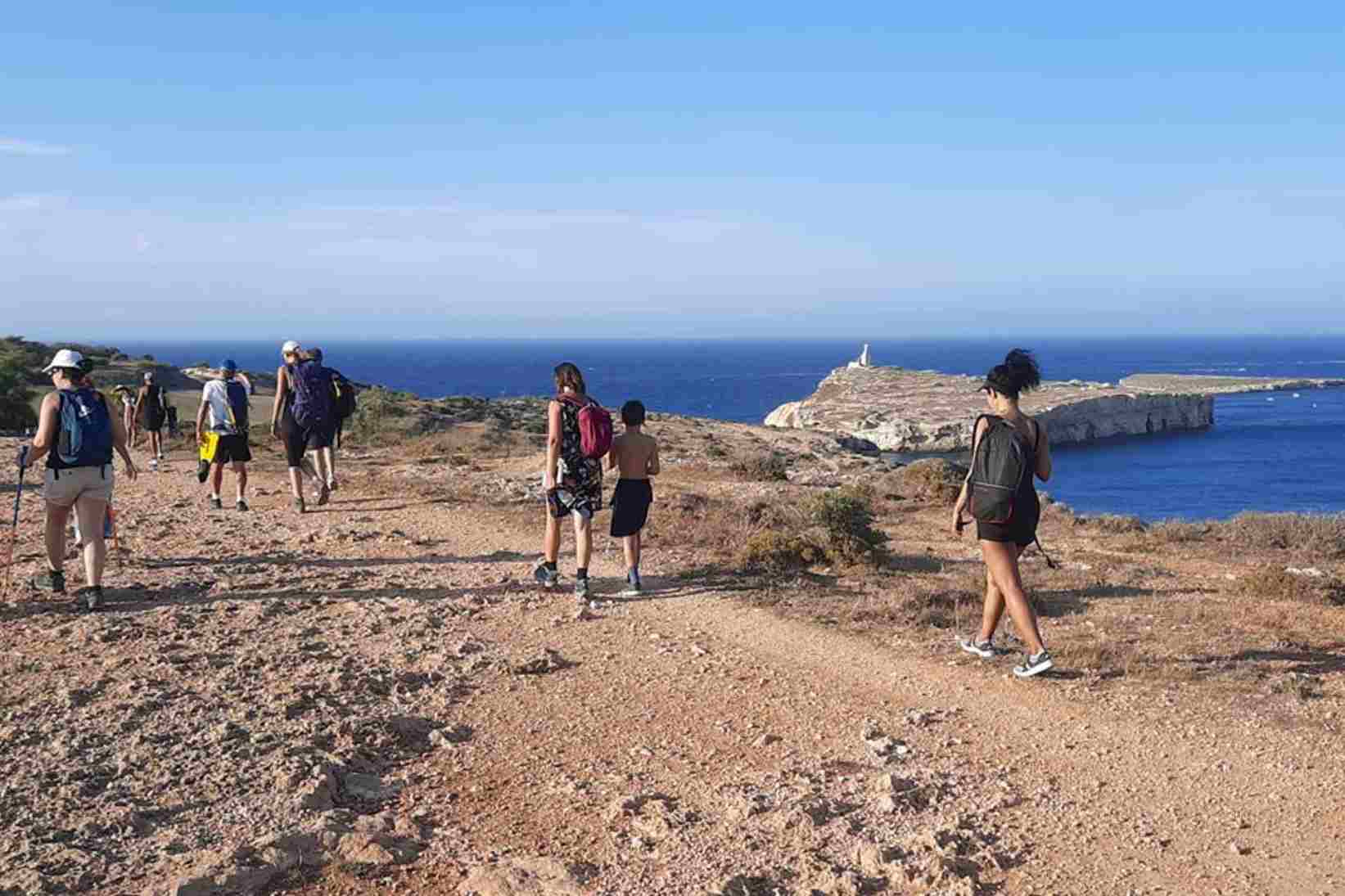 People trekking on Malta cliffs